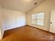 Bright bedroom with wood-look flooring and a window letting in natural light at 8551 Appledale Dr, Charlotte, NC 28262