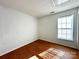 Cozy bedroom features wood-look flooring and a bright window at 8551 Appledale Dr, Charlotte, NC 28262