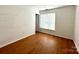 Well-lit bedroom with wood-look flooring and ample natural light at 8551 Appledale Dr, Charlotte, NC 28262