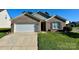 Charming brick home with well-maintained lawn and attached two-car garage, offering curb appeal at 8551 Appledale Dr, Charlotte, NC 28262