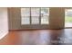 Spacious living room area with durable flooring, large windows and an accessible outdoor space at 8551 Appledale Dr, Charlotte, NC 28262