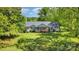 A bird's eye view of a one story home with beautiful surrounding trees and expansive green yard at 940 Hatchett Rd, Lincolnton, NC 28092