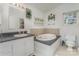 Bright bathroom featuring a garden tub with tile surround and vanity with decorative accents at 940 Hatchett Rd, Lincolnton, NC 28092