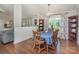Dining room with wood table and chairs, hardwood floors and large window with decorative curtains at 940 Hatchett Rd, Lincolnton, NC 28092