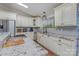 Kitchen with stainless steel appliances, white cabinetry, marble countertops, and mosaic tile backsplash at 940 Hatchett Rd, Lincolnton, NC 28092