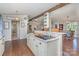 Kitchen island with seating, marble countertops, overhead lighting, and view of the living and dining rooms at 940 Hatchett Rd, Lincolnton, NC 28092