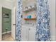 Laundry room area with washer, dryer, shelving, and floral curtain at 940 Hatchett Rd, Lincolnton, NC 28092