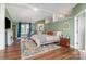 Main bedroom with a large bed, hardwood floors, a sitting area with comfortable furniture, and private bathroom at 940 Hatchett Rd, Lincolnton, NC 28092