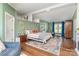 Spacious main bedroom featuring hardwood floors, bright windows, and ensuite bathroom access at 940 Hatchett Rd, Lincolnton, NC 28092