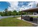 Landscaped backyard featuring a covered patio with outdoor seating and a well-maintained lawn at 9613 Fire Bellied Ct, Lancaster, SC 29720