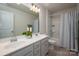 This bathroom features double sinks, updated cabinetry, and decorative mirrors at 9613 Fire Bellied Ct, Lancaster, SC 29720