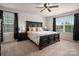 Main bedroom boasts a large bed, dark furniture, and bright windows at 9613 Fire Bellied Ct, Lancaster, SC 29720