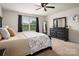 This bedroom features a ceiling fan, and a window view, complemented by matching furniture at 9613 Fire Bellied Ct, Lancaster, SC 29720