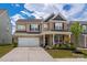 Charming two-story home with brick accents, landscaped front yard, and a two car attached garage at 9613 Fire Bellied Ct, Lancaster, SC 29720