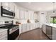 Bright kitchen features stainless steel appliances, white cabinets and counters, and a pantry at 9613 Fire Bellied Ct, Lancaster, SC 29720