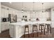 Modern kitchen with an island, stainless steel appliances, and white cabinetry at 9613 Fire Bellied Ct, Lancaster, SC 29720