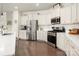 Well-lit kitchen features stainless steel appliances, white cabinetry, and a view of the breakfast nook at 9613 Fire Bellied Ct, Lancaster, SC 29720