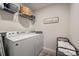 Well-lit laundry room featuring a washer, dryer, and shelving for organized storage at 9613 Fire Bellied Ct, Lancaster, SC 29720