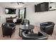 Comfortable living room with black furniture and large windows, perfect for relaxation and entertainment at 9613 Fire Bellied Ct, Lancaster, SC 29720