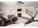 Open floor plan includes living room with fireplace, staircase, and plenty of seating at 9613 Fire Bellied Ct, Lancaster, SC 29720