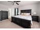 Spacious main bedroom features a dark, carved bed frame and direct access to the bathroom at 9613 Fire Bellied Ct, Lancaster, SC 29720