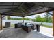 Relaxing outdoor patio with gazebo, stylish seating, fire pit, and views of the backyard at 9613 Fire Bellied Ct, Lancaster, SC 29720