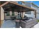 Spacious covered patio with an outdoor sofa, fire pit, dining area, and a wall-mounted TV at 9613 Fire Bellied Ct, Lancaster, SC 29720
