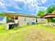 Exterior view of a home with back porch, picnic table, and a spacious backyard with green grass at 970 Mt Moriah Church Rd, China Grove, NC 28023