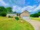 Well-maintained brick house with a front lawn and beautiful landscaping under a partly cloudy sky at 970 Mt Moriah Church Rd, China Grove, NC 28023