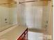 Bright bathroom featuring a bathtub and updated vanity with storage at 9832 Longstone Ln, Charlotte, NC 28277