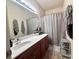 Well-lit bathroom with a large vanity, spacious countertop, and modern fixtures at 9832 Longstone Ln, Charlotte, NC 28277