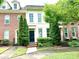 Charming townhome with manicured landscaping, a striking black door, and a welcoming facade at 9832 Longstone Ln, Charlotte, NC 28277