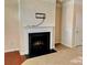 Cozy living room featuring a classic fireplace with a decorative mantle at 9832 Longstone Ln, Charlotte, NC 28277