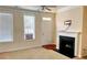 Comfortable living room with a fireplace, flooded with natural light from the windows at 9832 Longstone Ln, Charlotte, NC 28277