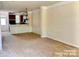Bright living room with neutral walls and an open layout leading to the kitchen at 9832 Longstone Ln, Charlotte, NC 28277