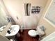 Compact powder room with a stylish pedestal sink, modern fixtures, and fresh decor at 9832 Longstone Ln, Charlotte, NC 28277