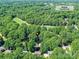 Aerial view of property in Raintree Country Club, surrounded by lush trees at 10024 Whitethorn Dr, Charlotte, NC 28277