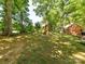 Expansive backyard featuring mature trees and a wooden playset at 10024 Whitethorn Dr, Charlotte, NC 28277