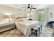 Comfortable bedroom with a large bed, decorative pillows, and a ceiling fan at 10024 Whitethorn Dr, Charlotte, NC 28277