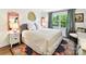 Cozy bedroom featuring a bed with patterned headboard, colorful rug, and bright natural light at 10024 Whitethorn Dr, Charlotte, NC 28277