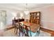 Formal dining room featuring elegant chandelier lighting, hardwood floors, and traditional furniture at 10024 Whitethorn Dr, Charlotte, NC 28277