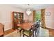 Formal dining room with a chandelier, hardwood floors, and a decorative china cabinet at 10024 Whitethorn Dr, Charlotte, NC 28277