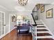 Classic foyer with hardwood floors, staircase with white railing, and stylish decor at 10024 Whitethorn Dr, Charlotte, NC 28277