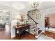 Charming foyer with wood floors, staircase, and decorative table with lamp at 10024 Whitethorn Dr, Charlotte, NC 28277