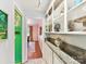 Hallway view showcasing built-in display shelving, granite countertops, and open access to dining area at 10024 Whitethorn Dr, Charlotte, NC 28277