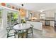 Bright kitchen with a breakfast nook featuring a round table, pendant lighting, and views of the backyard at 10024 Whitethorn Dr, Charlotte, NC 28277