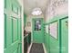 Colorful laundry room with green accents, patterned wallpaper, and modern washer/dryer at 10024 Whitethorn Dr, Charlotte, NC 28277