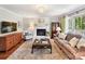 Comfortable living room featuring a fireplace, plush seating, and a decorative rug at 10024 Whitethorn Dr, Charlotte, NC 28277