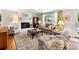 Inviting living room featuring a brick fireplace, plush seating, and large windows with decorative curtains at 10024 Whitethorn Dr, Charlotte, NC 28277