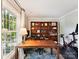 Bright office space with large window, a wooden desk, and custom built-in shelving at 10024 Whitethorn Dr, Charlotte, NC 28277